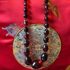 Elegant cherry faceted Bakelite 1930s graduated beaded necklace. 32”